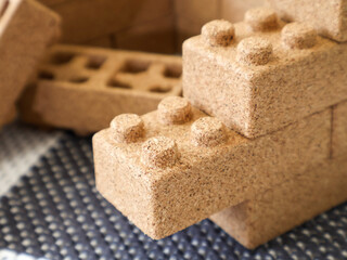 Macro close-up of cork construction blocks resembling toy bricks. Eco-friendly and lightweight material for safe children’s play.