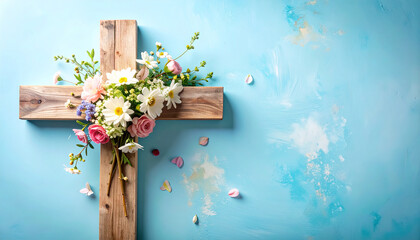 Wooden cross and colorful spring flowers on blue background. Easter, faith and religious celebration