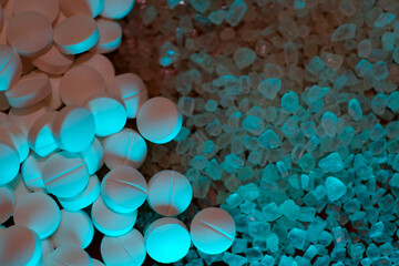 Top view of medicine and sugar under blue light