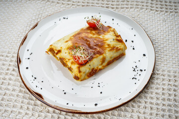puff pastry decorated with cherry tomatoes on a plate
