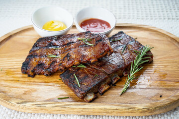 fried ribs on a wooden board on a white background macro photo