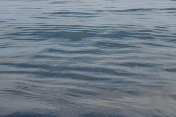 Naklejka premium Langrune-Sur-Mer, France - 08 07 2025: Sea background. Detail view of a dark blue water in the sea