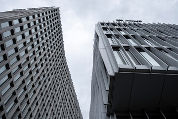 Twin office towers with geometric facade design, highlighting corporate architecture for finance, business, and economic growth, creating strong abstract visuals for financial oriented backgrounds.