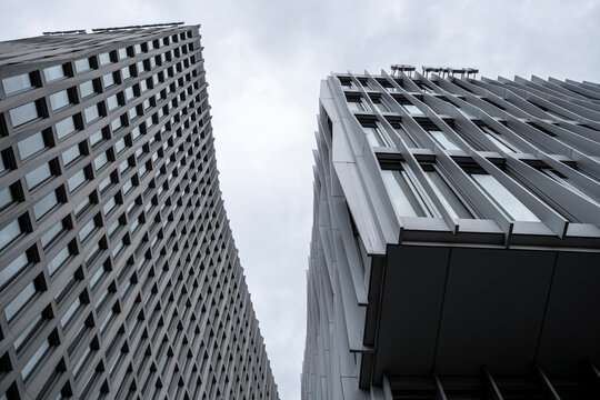 Twin office towers with geometric facade design, highlighting corporate architecture for finance, business, and economic growth, creating strong abstract visuals for financial oriented backgrounds.