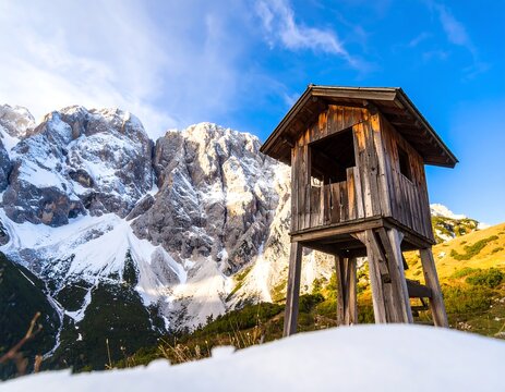 Alpine wooden lookout with snow-capped peaks - Powered by Adobe