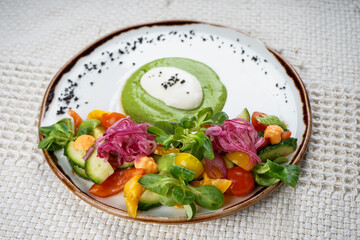Fresh vegetable salad, tomatoes, cucumber, paprika and herbs in a plate