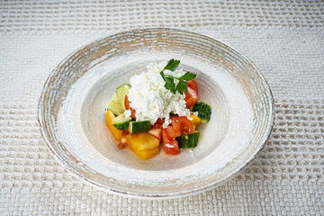 Fresh vegetable salad, tomatoes, cucumber, paprika in a plate