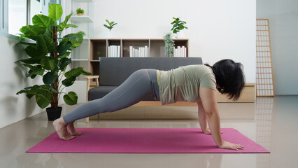 Inclusive Fitness: Woman in Plank Position on Yoga Mat