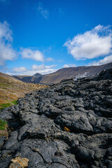 Iceland’s black lava fields stretch toward the horizon under a crisp blue sky, a dramatic reminder of the island’s volcanic power and wild beauty
