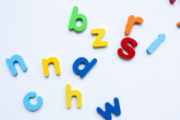 Colorful alphabet letters scattered on white background