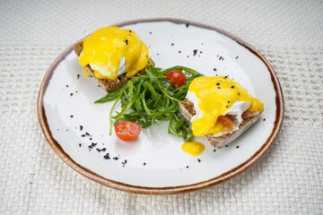 breakfast with poached egg in a plate with microgreens