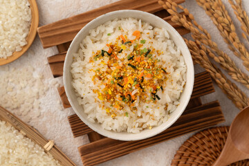 A bowl of white rice topped with sprinkle rice seasonings.