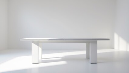 A modern white table with minimalist design placed in a bright, empty room with natural light.