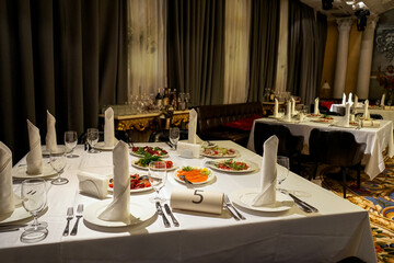 variety of dishes on served tables in a restaurant on plates