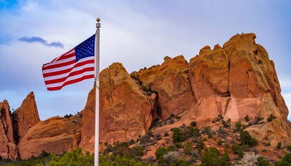 American flag waving over sandstone rock formations