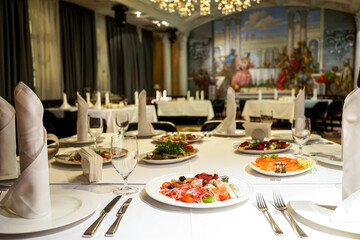 variety of dishes on served tables in a restaurant