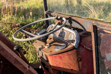 Abandoned and Rusting Farm Agricultural Tractor Interior on a Summer Evening