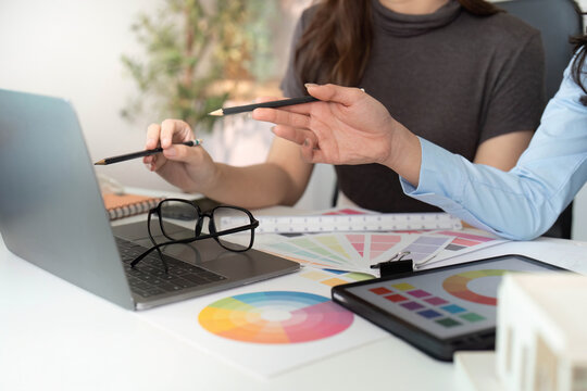 Designers Analyzing Color Options on Laptop