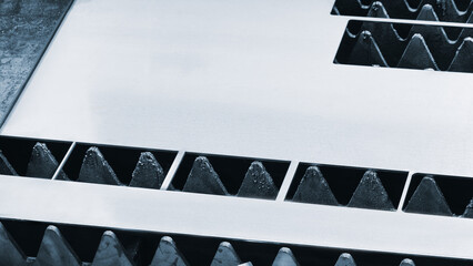 metal sheet is placed on the surface. plate is made of metal and has a rough texture. It is placed...