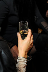 a glass of prosecco in the hands of a girl