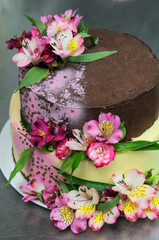 a large two-tiered cake decorated with flowers
