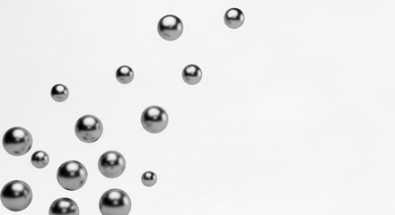 Numerous metallic spheres of varying sizes are scattered across a clean white background with subtle lighting creating reflections on their surfaces ball