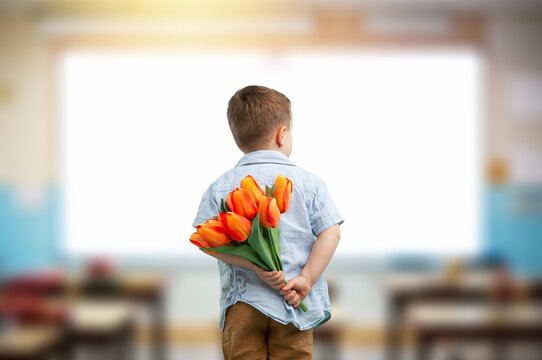 Child with beautiful bouquet of tulips. Women's Day. - Powered by Adobe