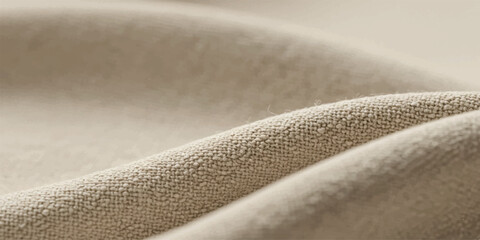 Soft, textured fabric with gentle folds and a warm, neutral beige color, highlighting the subtle surface details and natural drape
