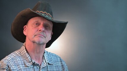 Closeup portrait of senior cowboy with hat  in a vintage Harcourt style lighting - Powered by Adobe