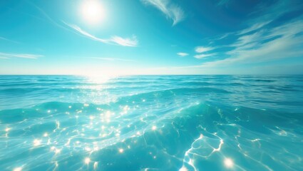 A clear blue ocean under the bright sun with sparkling water and a partly cloudy sky. The scene depicts a calm sea and sunny weather.