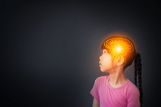 Concept of brain nervous system. Children study and learn , thought process and psychology of children. Cute girl looking up and thinking with hologram image of brain on blank background for text.