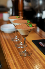 tiramisu desserts in glasses on the bar counter