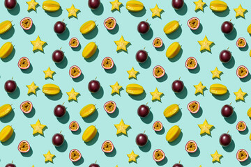 Starfruit and passion fruit seamless pattern on a teal background