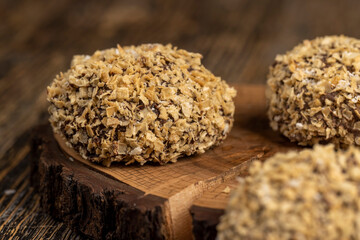 whole sweet marshmallows in chocolate sprinkled with crumbs from waffle , sweet dessert marshmallows in milk chocolate with crumbs