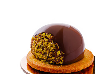 Decadent chocolate pastry dessert with pistachio layer and cookie base