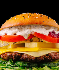 Tasty gourmet burger with fresh ingredients and rich toppings