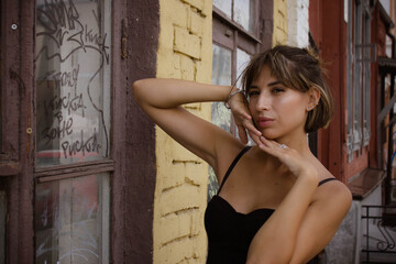 Fototapeta premium portrait of a young brunette woman in a black dress
