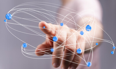 Abstract image of a hand interacting with a digital network, representing connection, technology,...