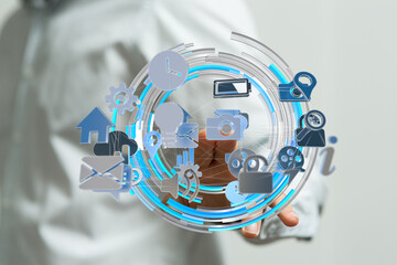 Hand interacting with a digital interface showing various app icons, representing modern technology and connectivity.