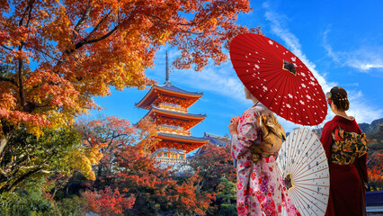 Japanese Woman in Traditional Kimono Dress at Kiyomizu-dera temple with beautiful foliage in autumn in Kyoto, Japan