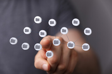 Person interacting with a digital network of files.  Cloud storage, data management concept.