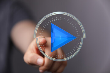 Abstract image of a hand interacting with a digital play button interface. Perfect for technology, media, and innovation concepts.
