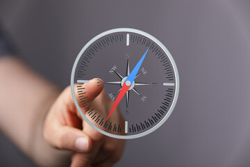 Hand pointing at a digital compass, symbolizing guidance and direction. Perfect for business,...