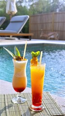 Tropical cocktails resting on bamboo mat beside pool, decorated with pineapple slice and mint sprig, surrounded by lounge chairs and lush greenery