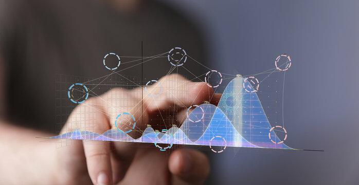 Business person analyzing data visualizations on a touchscreen.  Stock photo of data analysis and digital technology.