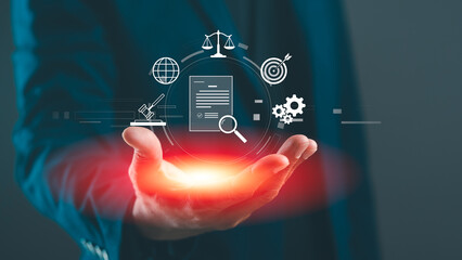 A businessman holds a glowing interface displaying various icons related to law, technology, and data analysis, symbolizing digital innovation and legal services.