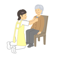 高齢者の着替えを介助する介護士