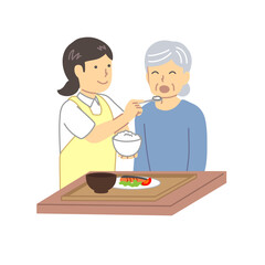 高齢者の食事介助をする介護士