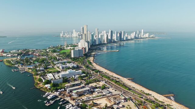 Slow motion aerial view of cartagena's coastline, showcasing its expanding urban development, bocagrande, colombia