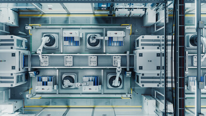 Top Down Shot of a High Tech Factory with Robotic Arms Assembling Electronic Components on a Production Line Conveyor Belt. Automation and Artificial Intelligence in a Modern Manufacturing Process